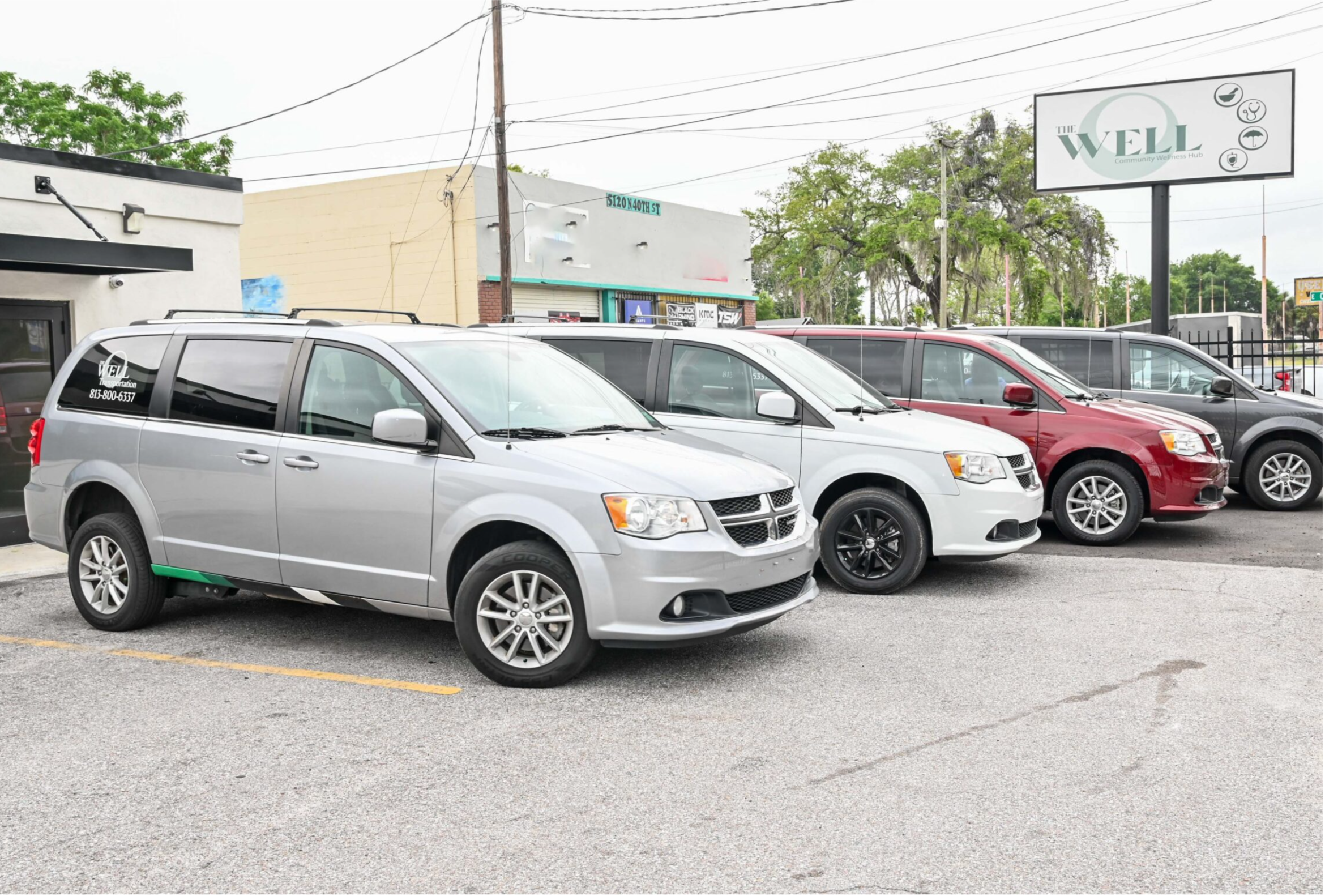 The Well Transportation fleet of accessible vans parked outside our Tampa location